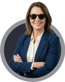 Smiling woman wearing sunglasses with arms crossed